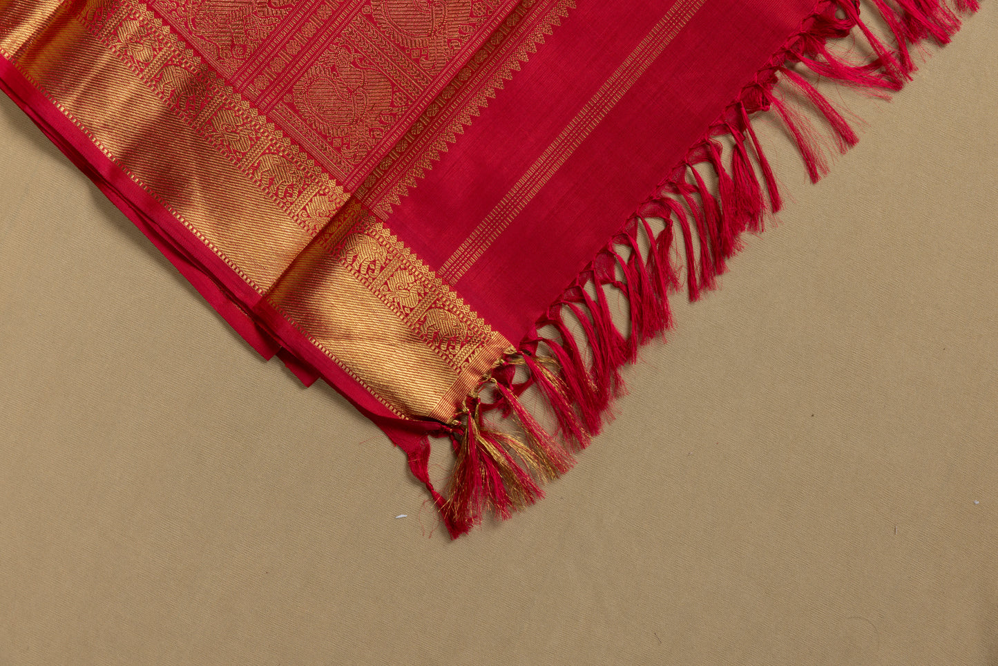 Tomato red Kanjivaram saree with gold border