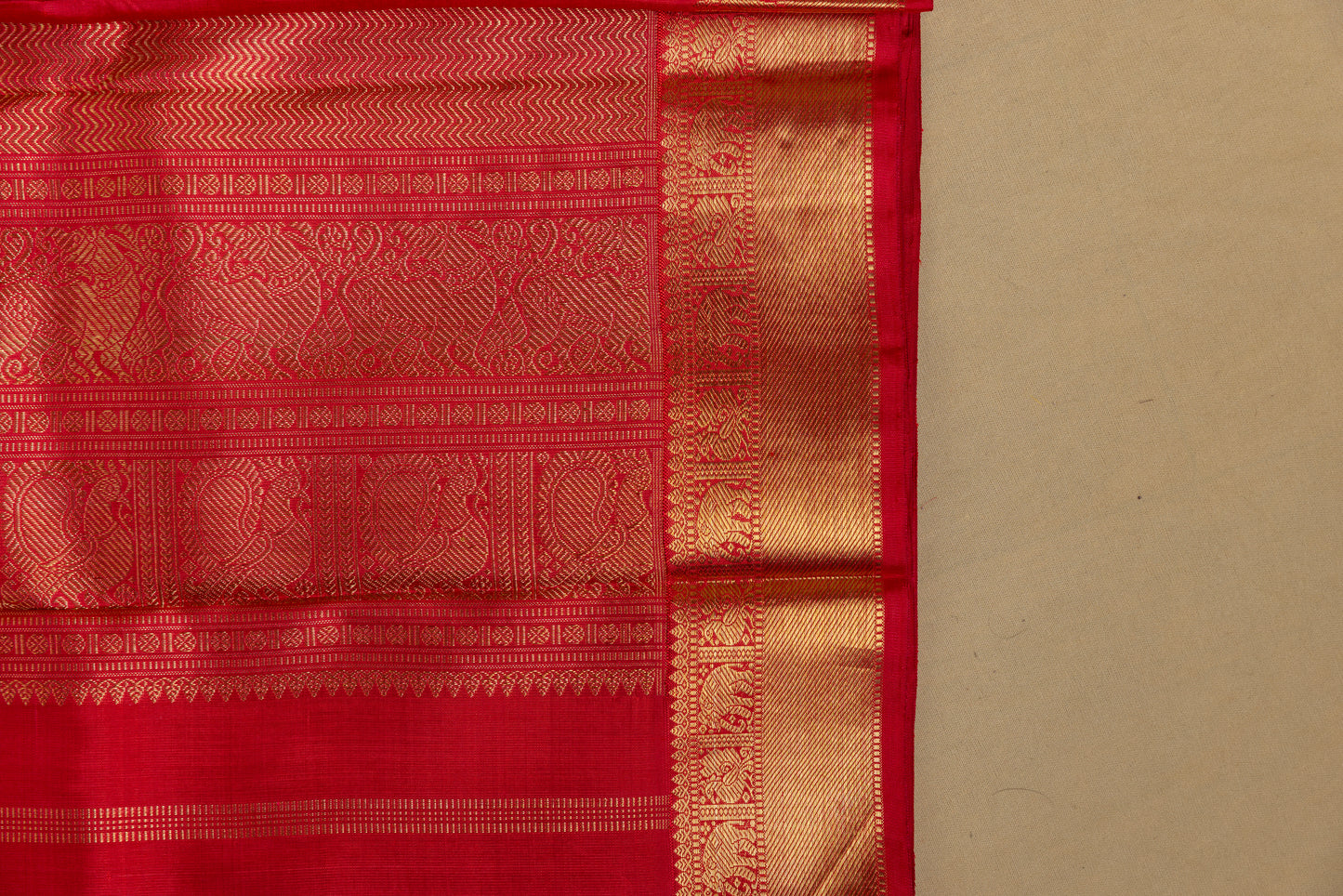 Tomato red Kanjivaram saree with gold border