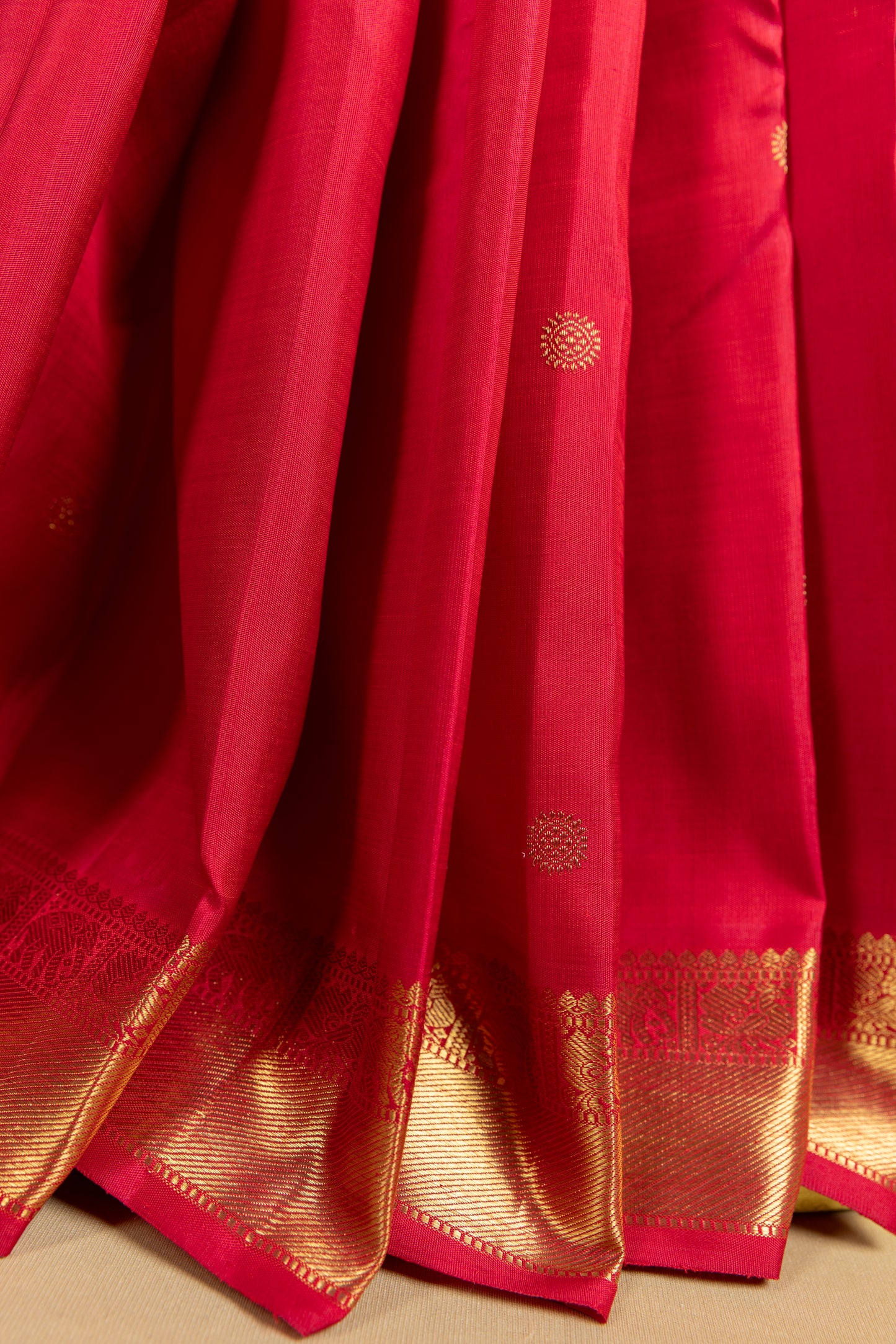 Tomato red Kanjivaram saree with gold border