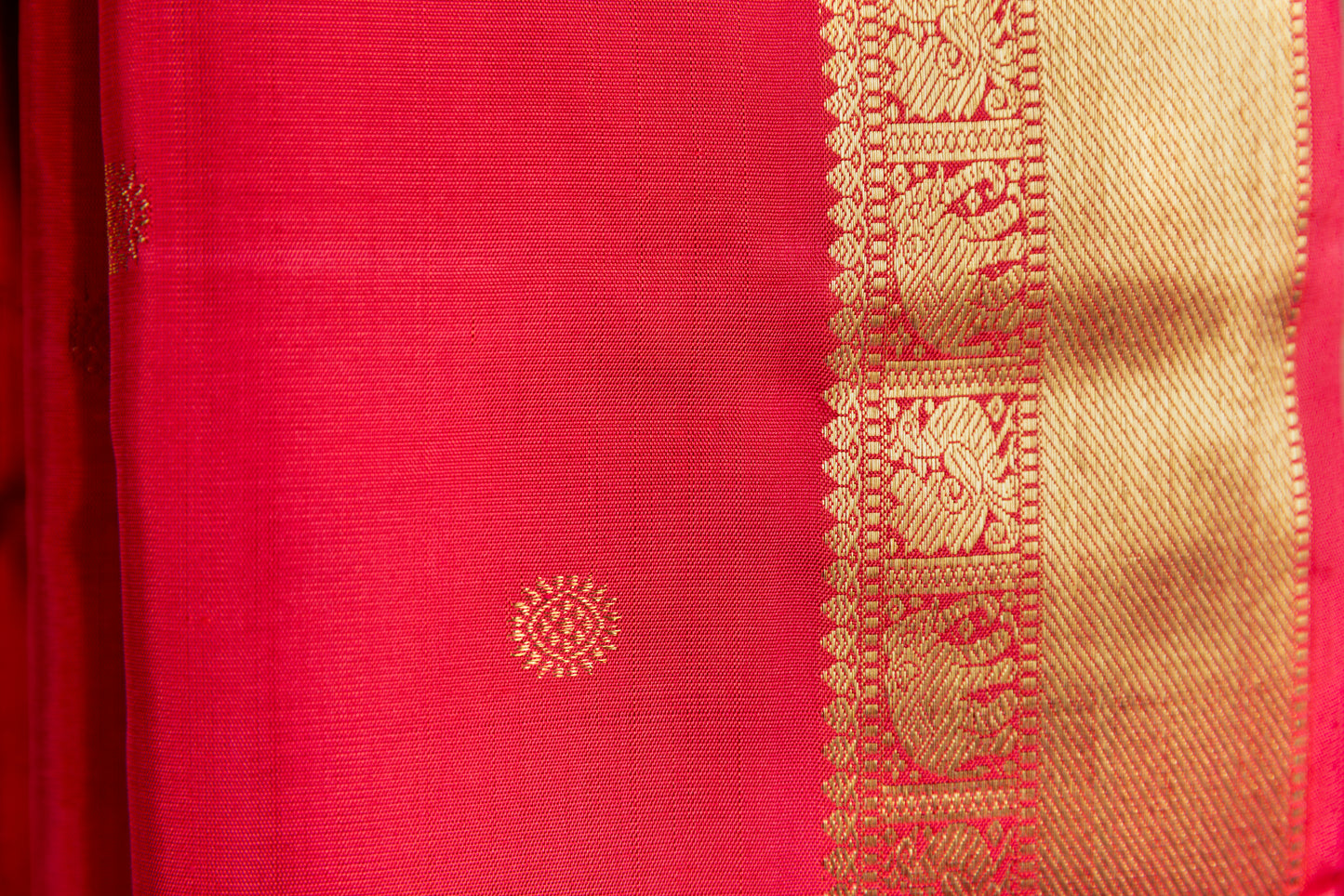 Tomato red Kanjivaram saree with gold border