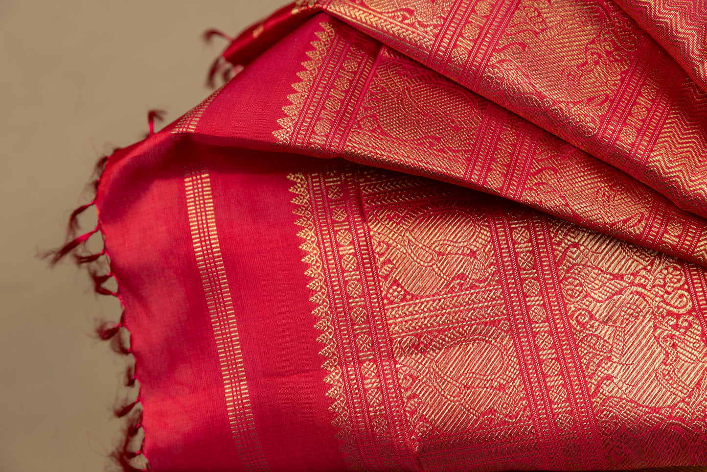 Tomato red Kanjivaram saree with gold border