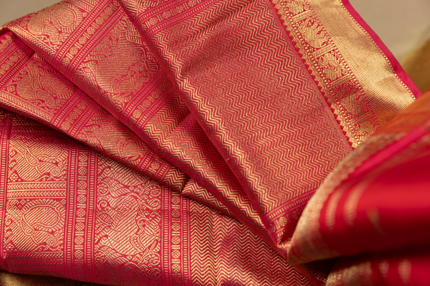 Tomato red Kanjivaram saree with gold border