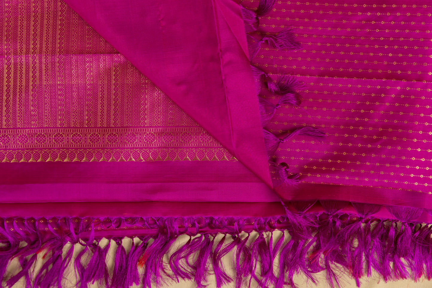 Magenta Kanjivaram saree with gold pin stripes and gold pallu