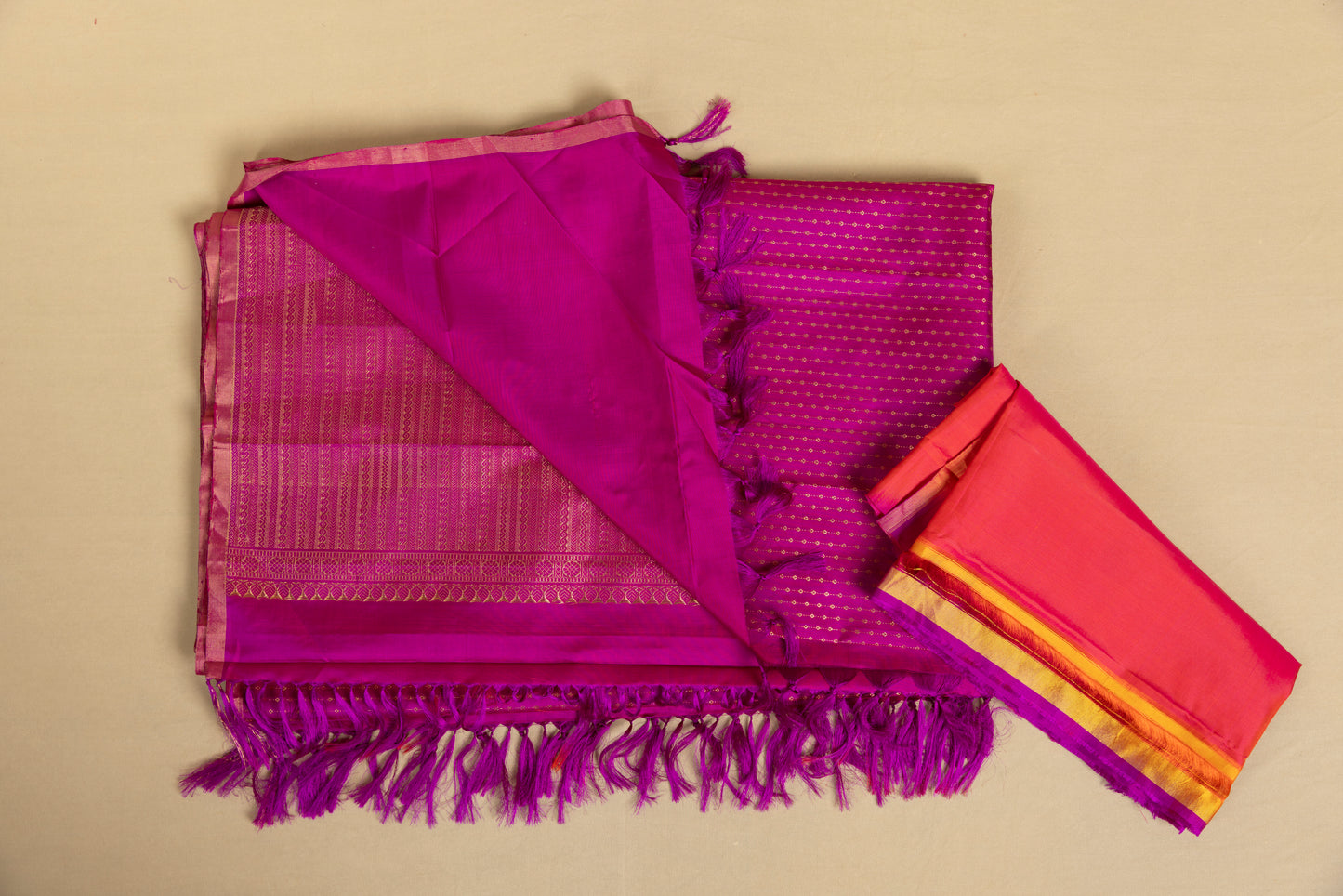 Magenta Kanjivaram saree with gold pin stripes and gold pallu