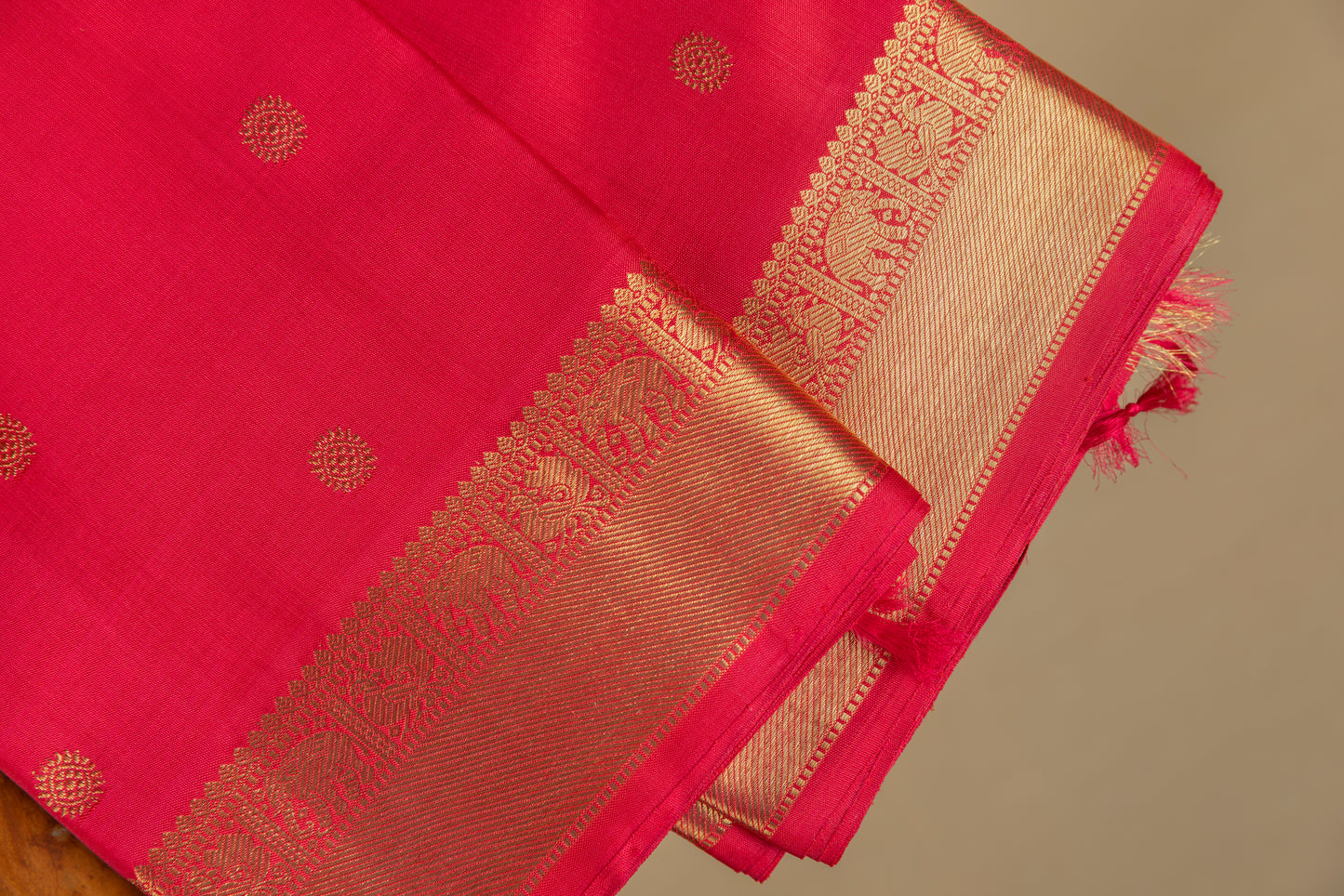 Tomato red Kanjivaram saree with gold border