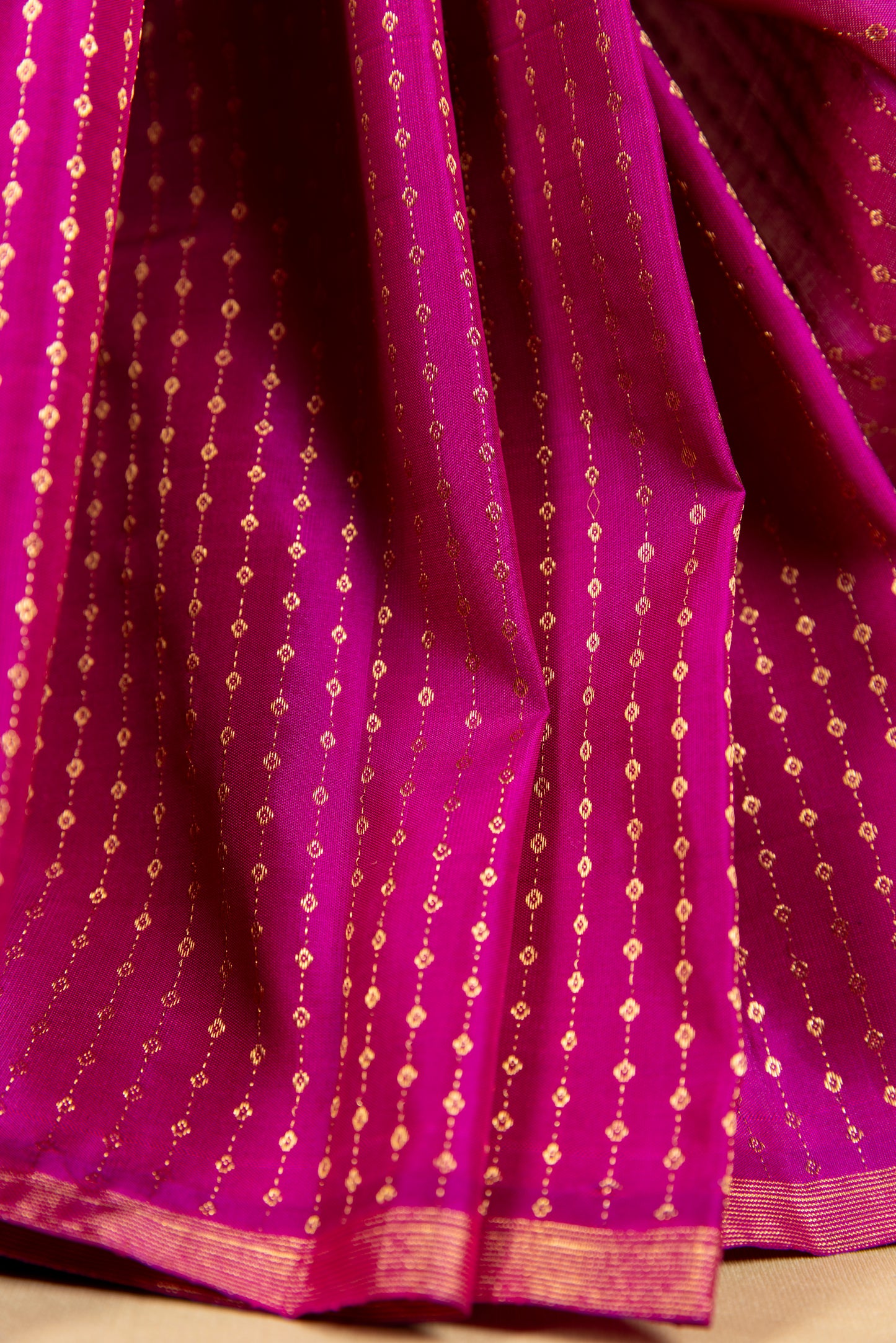 Magenta Kanjivaram saree with gold pin stripes and gold pallu