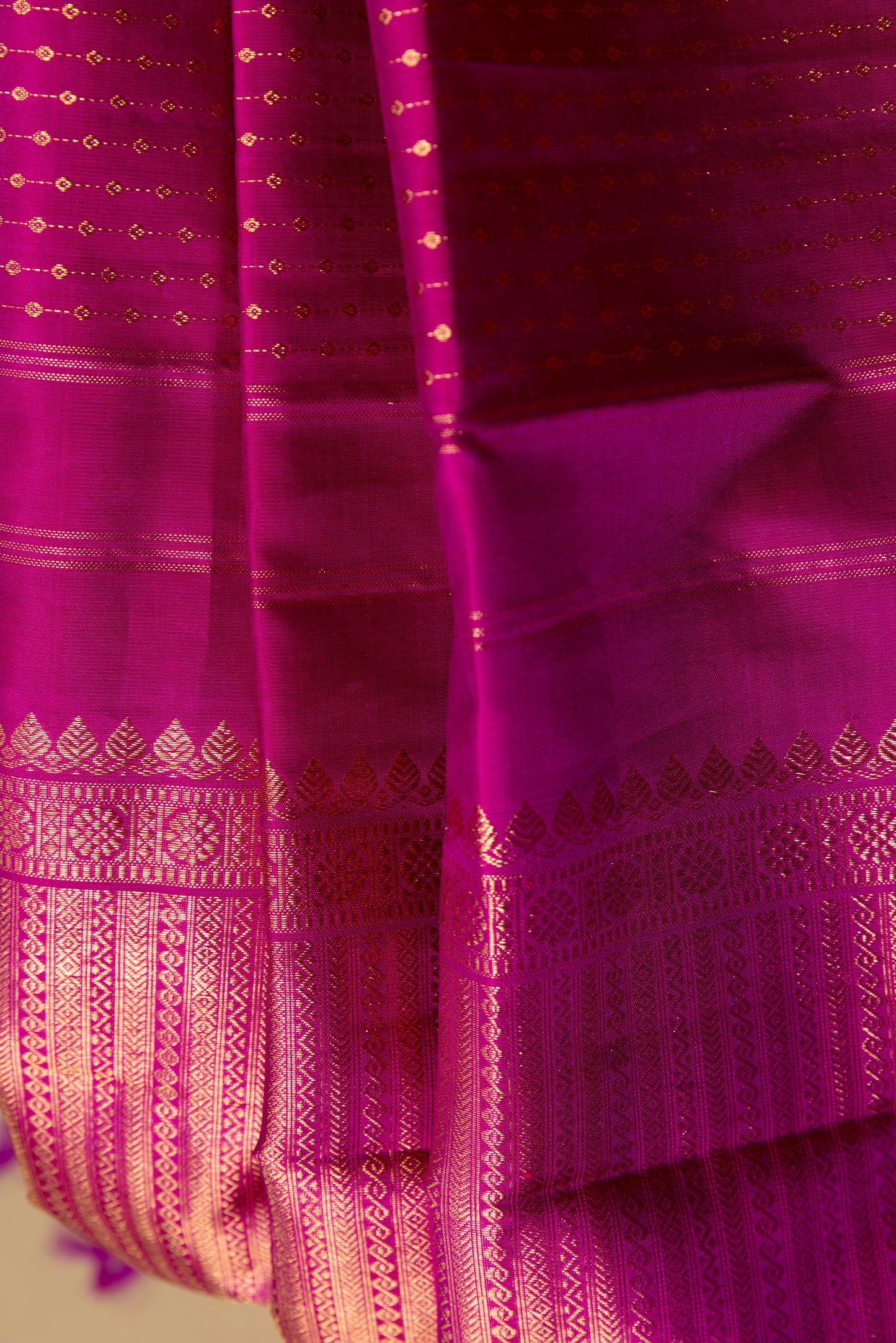 Magenta Kanjivaram saree with gold pin stripes and gold pallu