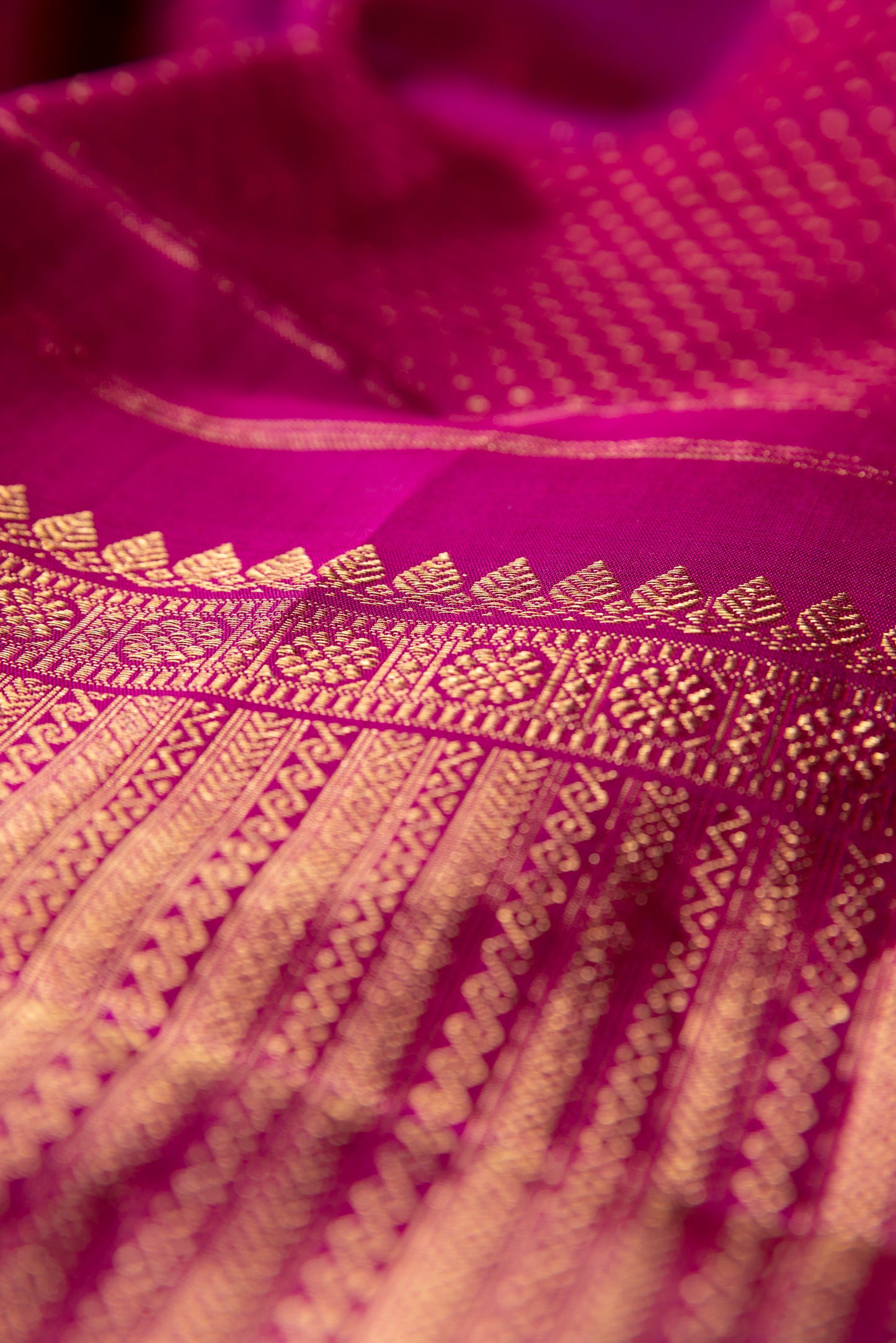 Magenta Kanjivaram saree with gold pin stripes and gold pallu