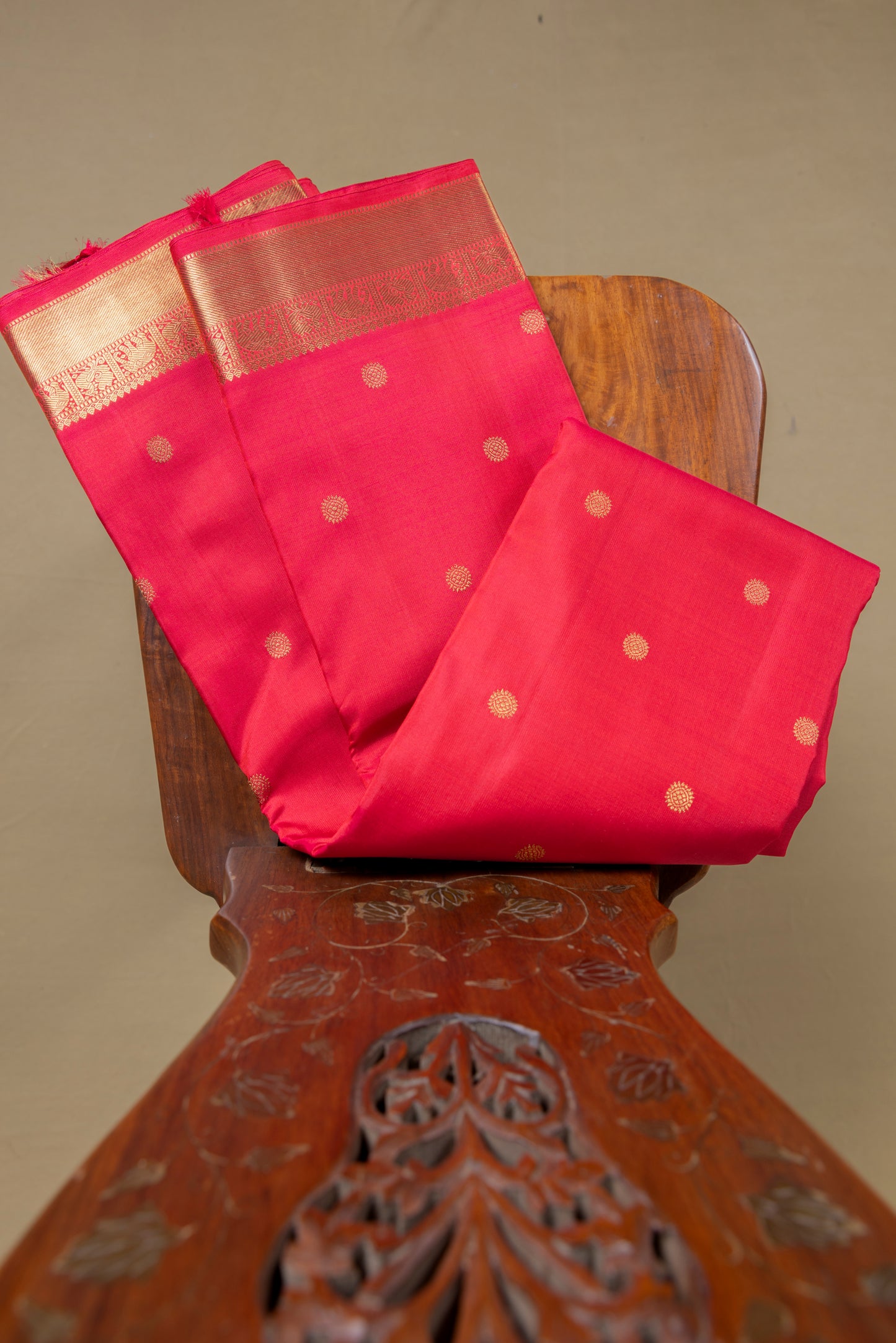 Tomato red Kanjivaram saree with gold border