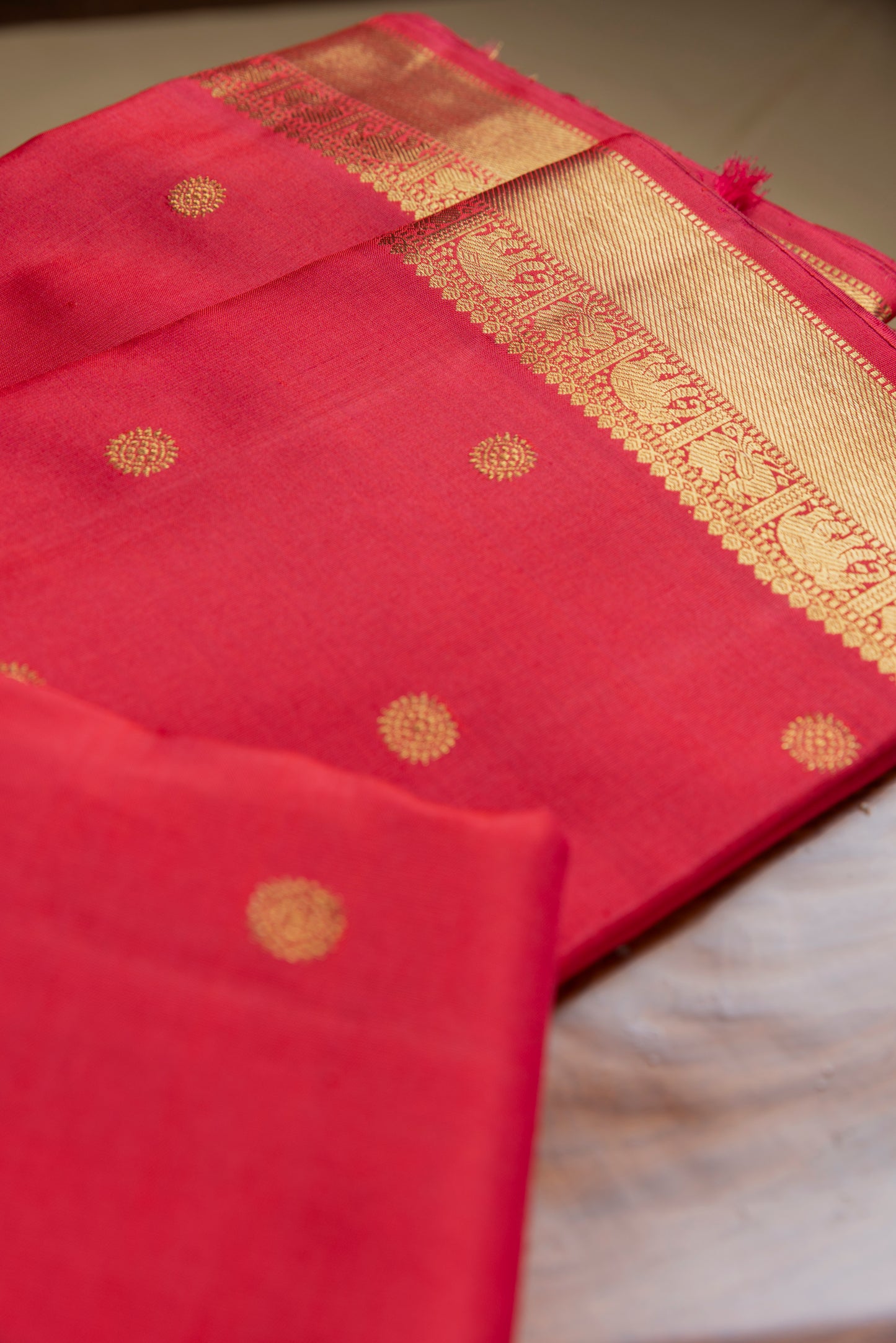 Tomato red Kanjivaram saree with gold border