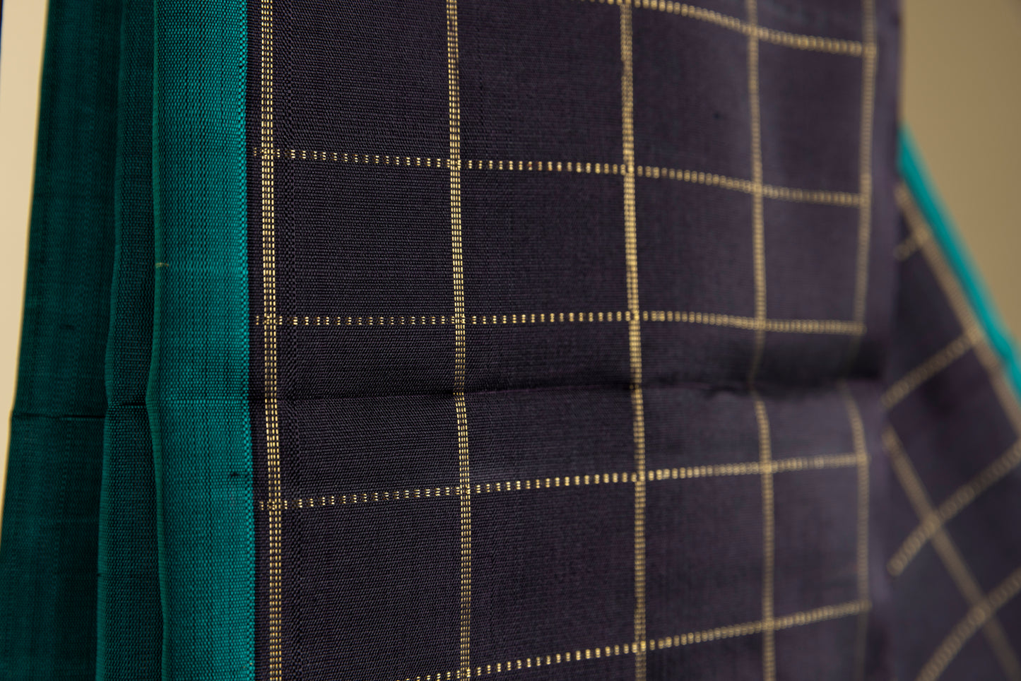 Black and green Kanjivaram saree with gold checks